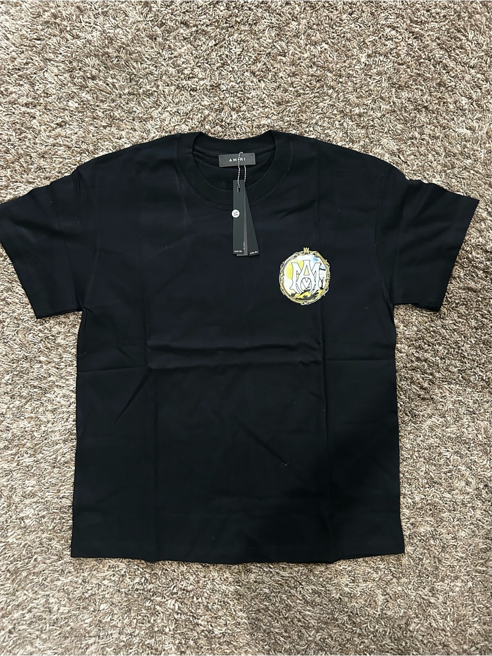 AMIRI Black Short‑Sleeve Tee with Yellow Crest Logo